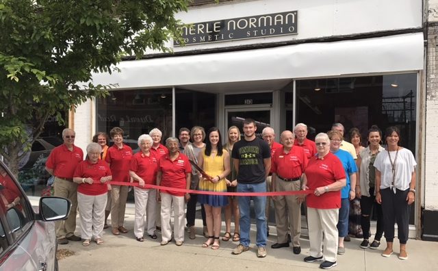 Merle Norman franchise owners at ribbon cutting