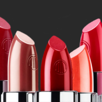 Merle Norman cosmetic franchise multi colored lipsticks are shown against a gray background